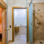 HOME Luxurious spa bathroom featuring a sauna and modern shower. Perfect for relaxation.